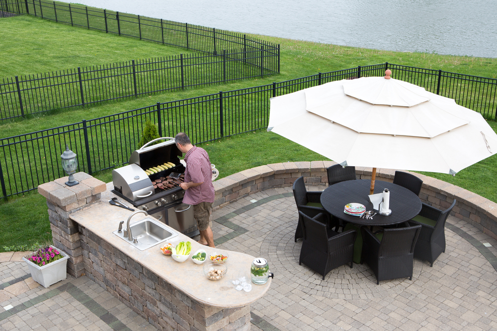 Man cooking outdoors - Orion Turf and Landscape