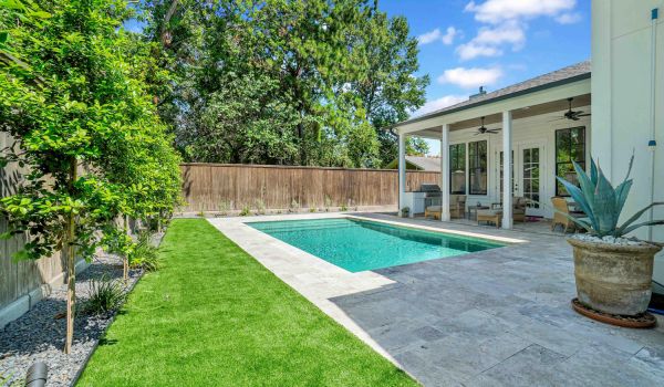 Backyard patio and swimming pool with artificial grass - Orion Turf and Landscape